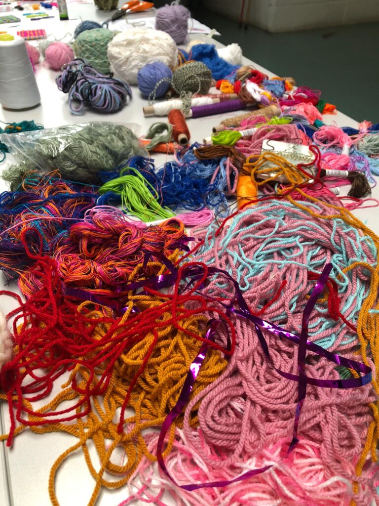 A pile of yarn of various colours.