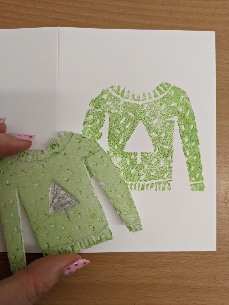 A lime green jumper has been stamped from a hand carved foam block.
