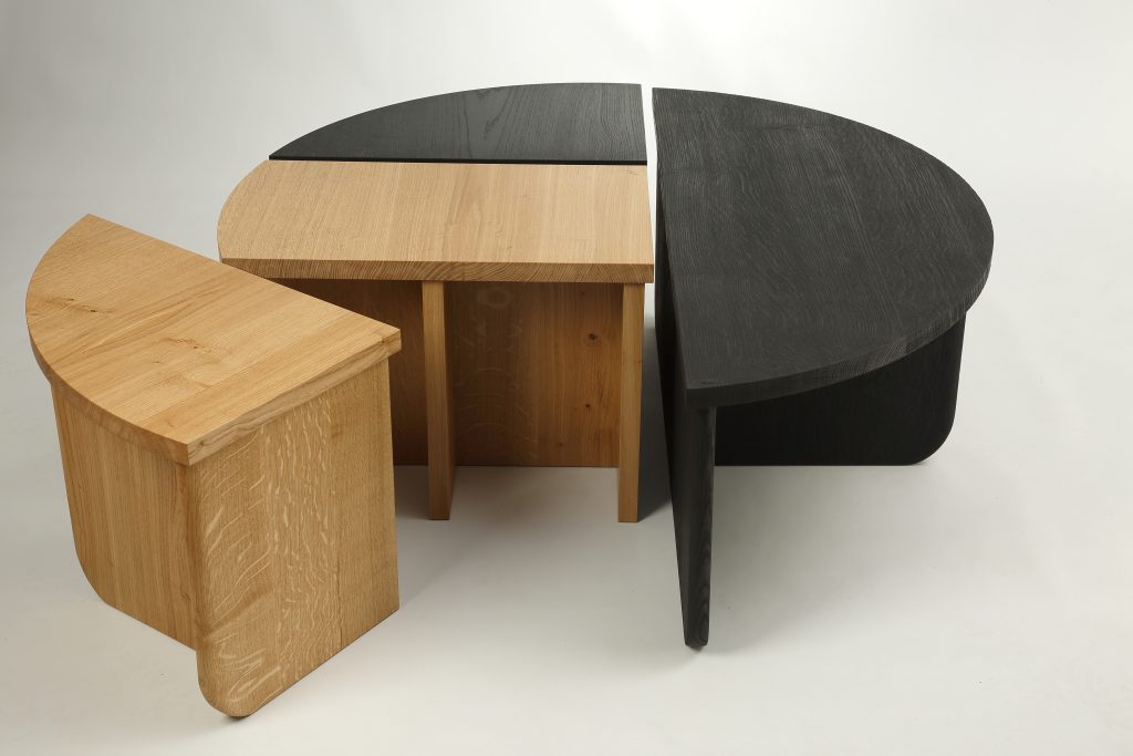 An oak table, made up of four tables, with one pulling away.