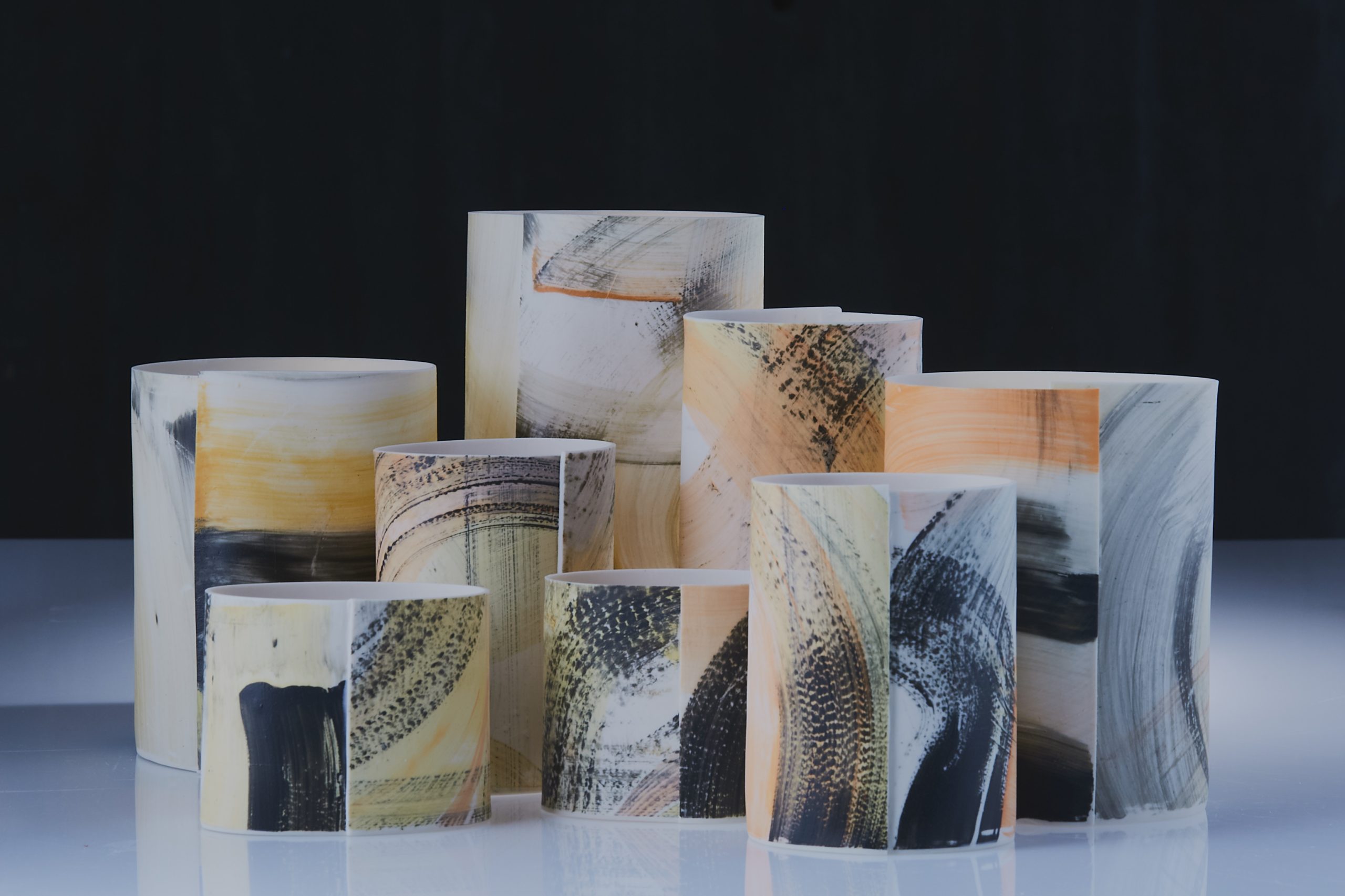 Series of Porcelain hand built cylinders with energetic and colourful brush marks