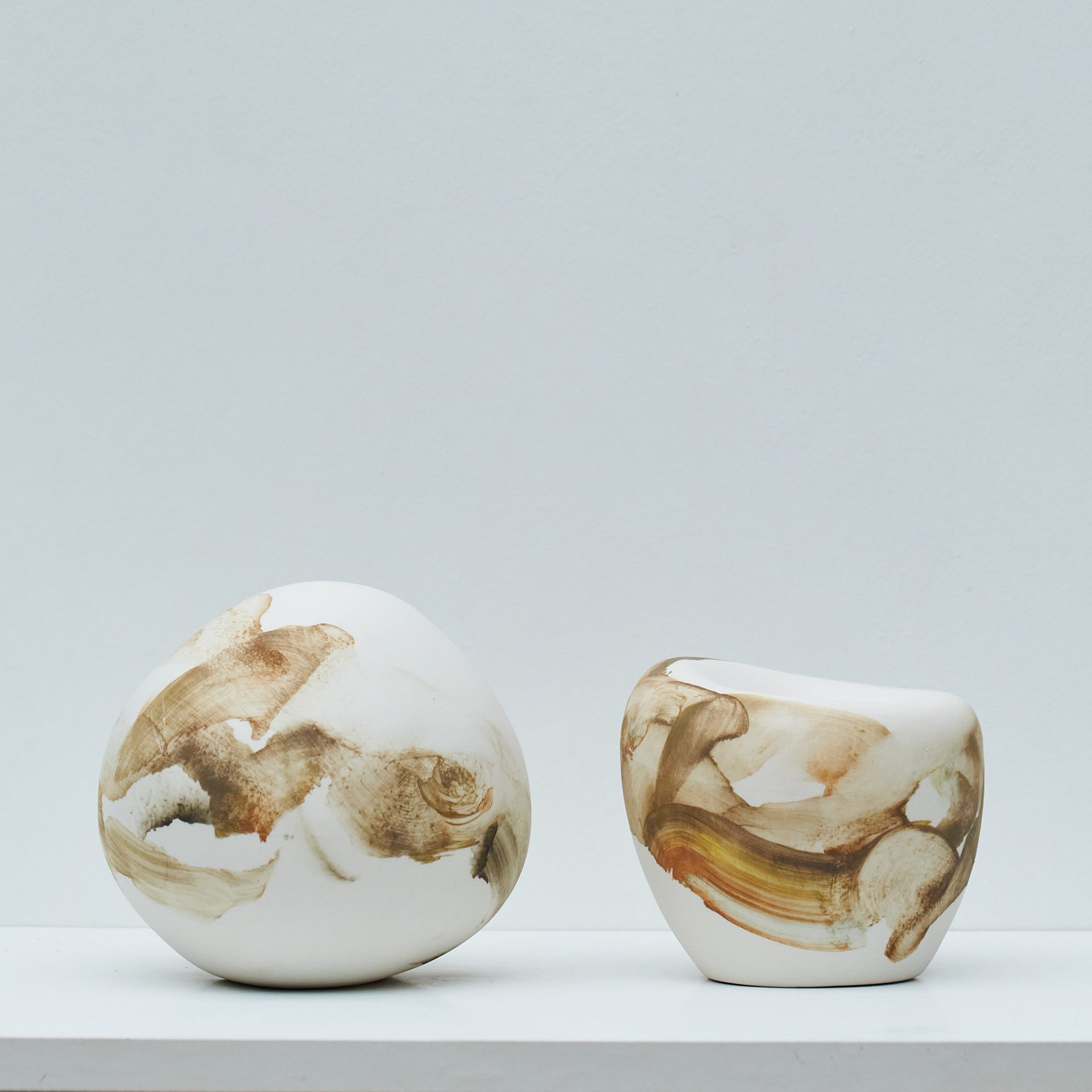 Green hues on smooth porcelain sculpture forms